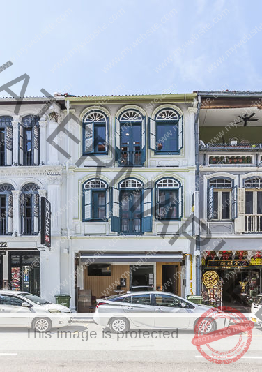 The facade of 21 Mosque Street, with neighbouring shophouses